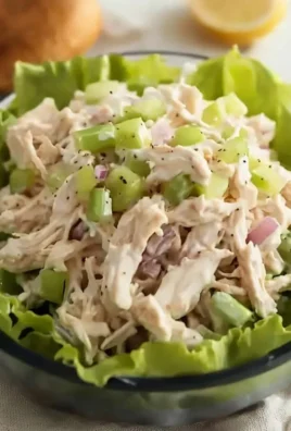 Bowl of classic chicken salad with fresh vegetables and dressing