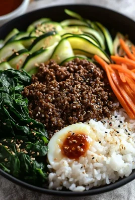 Easy bibimbap with ground beef served in a bowl with colorful vegetables.