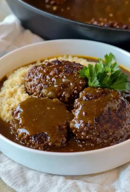 Delicious easy Salisbury steak served with gravy and mashed potatoes.