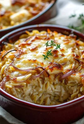 French onion chicken orzo casserole dish with melted cheese and herbs