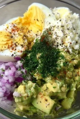 Herby avocado egg salad served in a bowl with fresh herbs