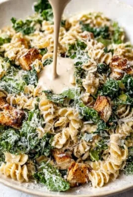 A vibrant Kale Caesar Pasta Salad with creamy dressing and croutons