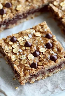 Delicious homemade oatmeal chocolate chip bars on a wooden table
