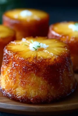 Pineapple mascarpone upside-down mini cakes displayed on a white plate.