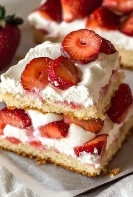 Delicious sheet pan strawberry shortcake with fresh strawberries and whipped cream.