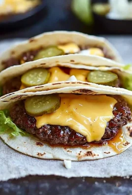 Smash burger tacos with savory burger sauce garnished on a plate