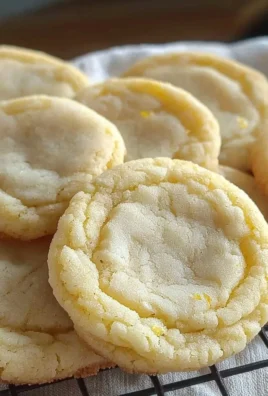 Freshly baked Soft and Chewy Lemon Cookies on a cooling rack