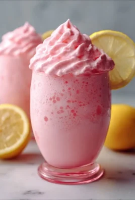 Refreshing whipped pink lemonade with a creamy texture served in a glass.