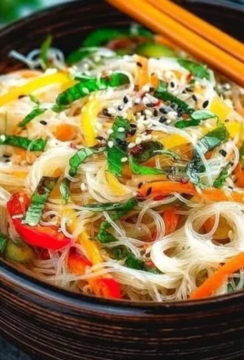 Yum Woon Sen - Cold Thai Glass Noodle Salad garnished with fresh vegetables.