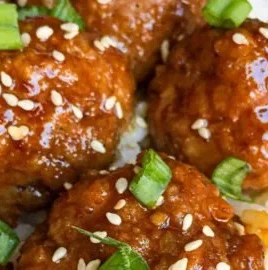 Delicious Asian glazed meatballs served on a platter with garnish
