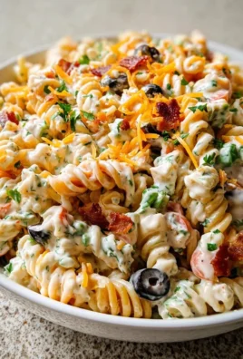 A vibrant bowl of Bacon Ranch Pasta Salad with crispy bacon and fresh veggies.