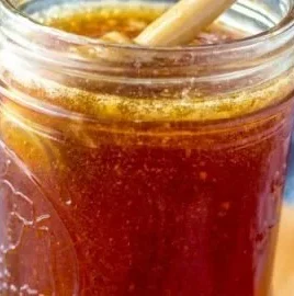 Jar of Chile Infused Honey showcasing its vibrant color and spicy ingredients