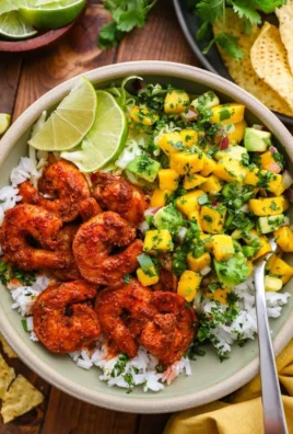 Chili lime shrimp bowls with mango-avocado salsa served in a white bowl.