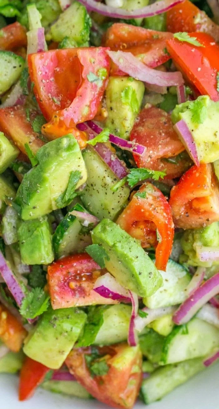 Cucumber Tomato Avocado Salad with fresh vegetables and herbs