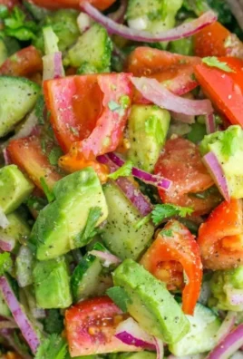 Cucumber Tomato Avocado Salad served in a bowl with vibrant ingredients