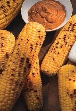 Delicious grilled corn with honey-ancho chile butter served at a summer barbecue