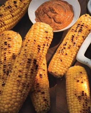 Delicious grilled corn with honey-ancho chile butter served at a summer barbecue