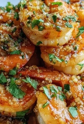 Plate of Hawaiian Garlic Shrimp garnished with herbs and served with rice
