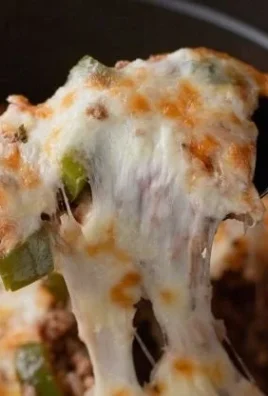 Healthy stuffed bell pepper casserole with colorful vegetables and grains.
