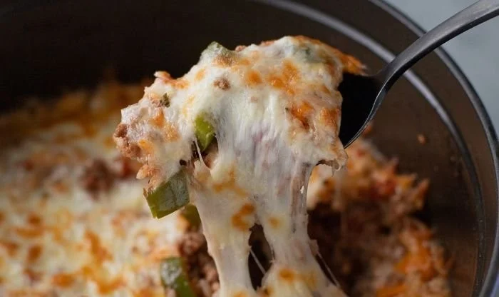 Healthy stuffed bell pepper casserole with colorful vegetables and grains.