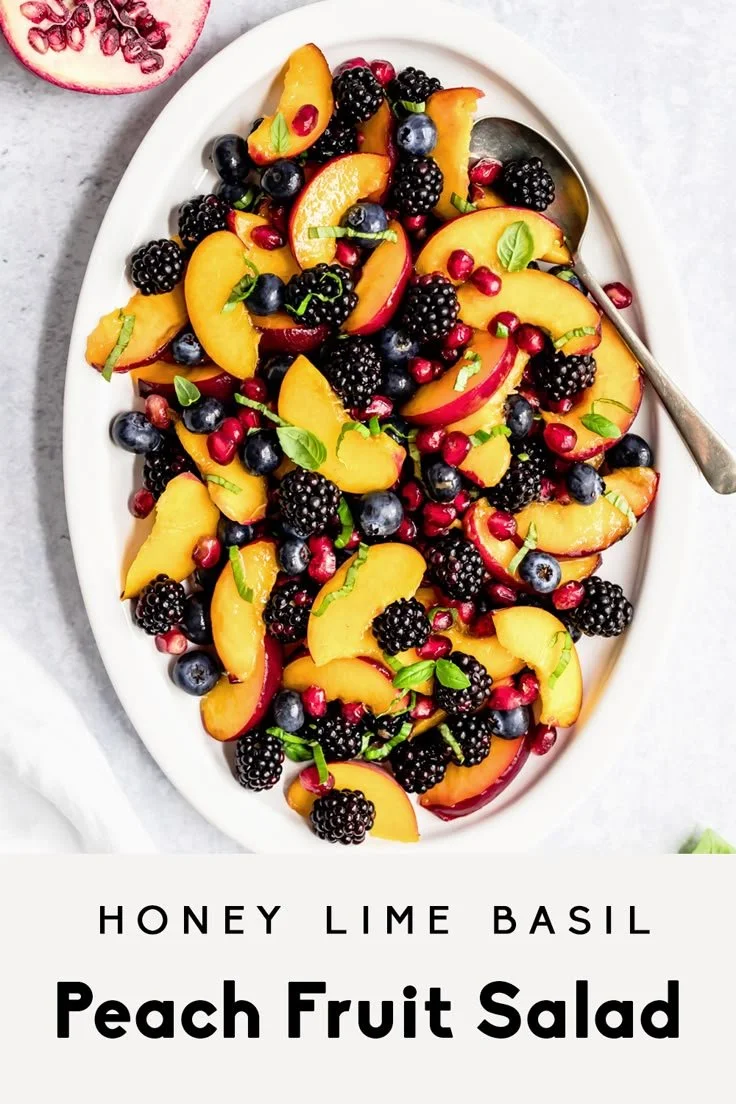Honey Lime Basil Peach Fruit Salad with fresh peaches and basil in a bowl