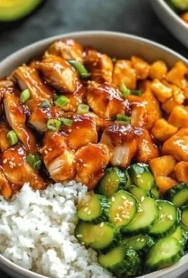 Hot honey chicken bowl topped with fresh veggies and drizzled with honey glaze.