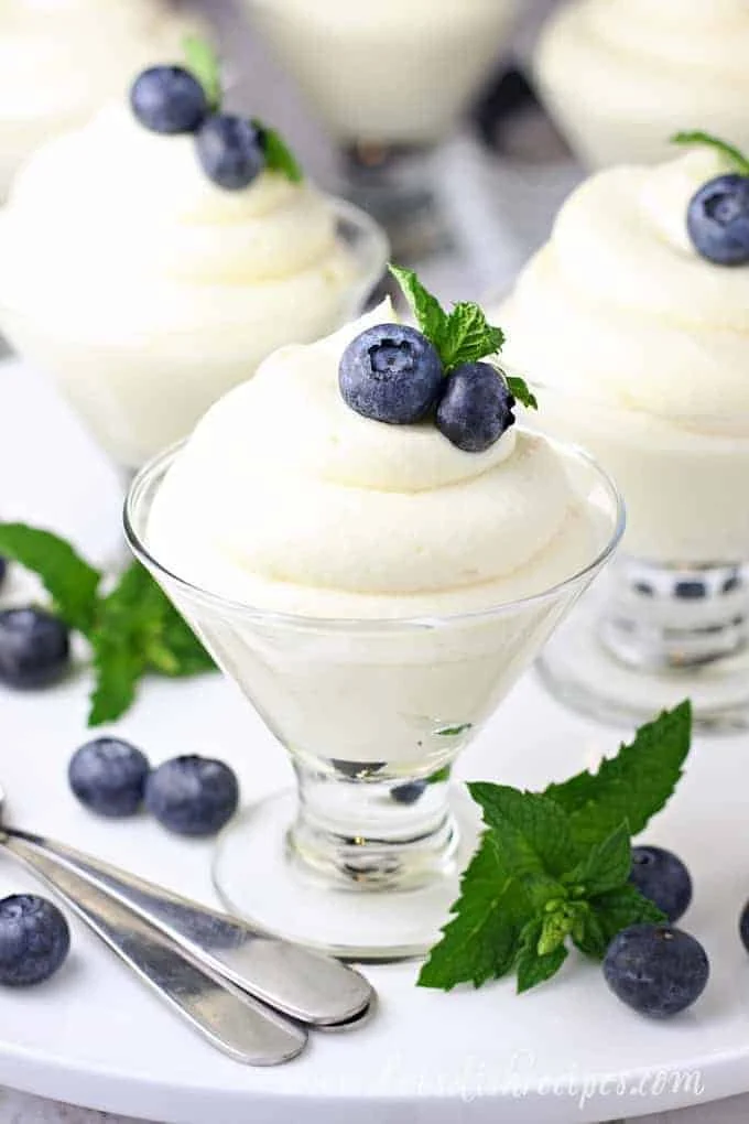 Delicious Lemon Cheesecake Mousse dessert topped with lemon zest.