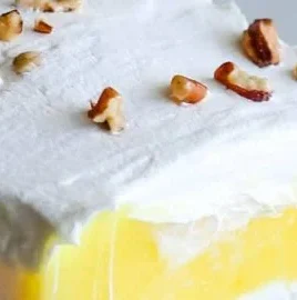 Delicious Lemon Lush dessert with creamy lemon layers on a plate