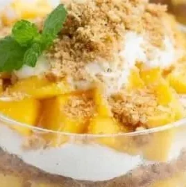 Mini Mango Floats with whipped cream and mango slices in a glass