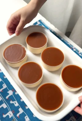No-Bake Salted Caramel Cheesecake Cups topped with caramel sauce and sprinkled sea salt