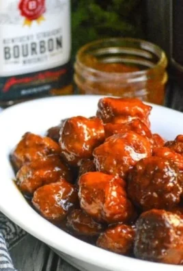 Delicious Peach Bourbon Meatballs served on a plate with sauce and garnish