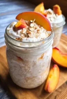 Peaches and Cream Overnight Oats in a jar with fresh peach slices