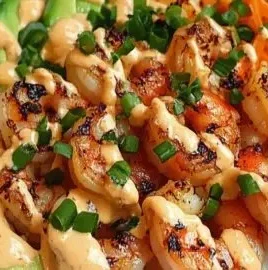 Shrimp rice bowls garnished with spicy mayo and fresh vegetables