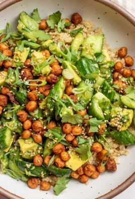 Smashed cucumber avocado salad with fresh ingredients in a bowl