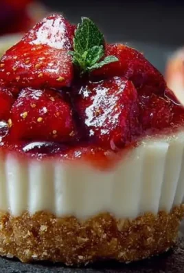 No-bake strawberry cheesecake cups served in clear glasses with fresh strawberries