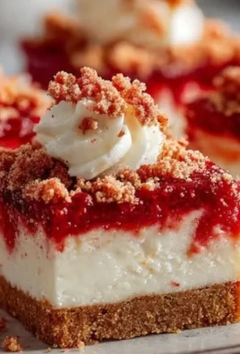 Delicious Strawberry Crunch Cheesecake Bars topped with crunchy strawberry crumbs