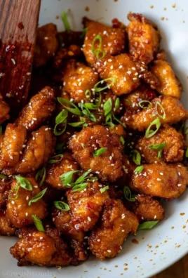 Plate of Sweet Chili Chicken garnished with herbs and served with rice