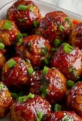 Plate of homemade Sweet Chili Meatballs garnished with green onions.