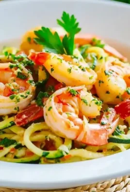 Zucchini Shrimp Scampi served on a plate with garlic and herbs