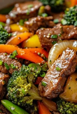 Beef stir fry with colorful vegetables on a serving plate