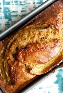 Slice of brown-butter banana bread on a white plate.