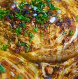 Oven-roasted cabbage steaks served with herbs and spices