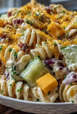 Creamy dill pickle pasta salad in a bowl with fresh ingredients