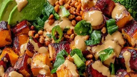 Delicious Thai Peanut Buddha Bowl with sweet potatoes and healthy toppings