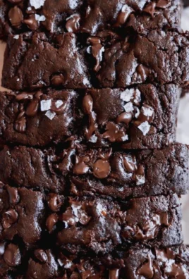Slice of double chocolate banana bread with chocolate chips on a rustic wooden table