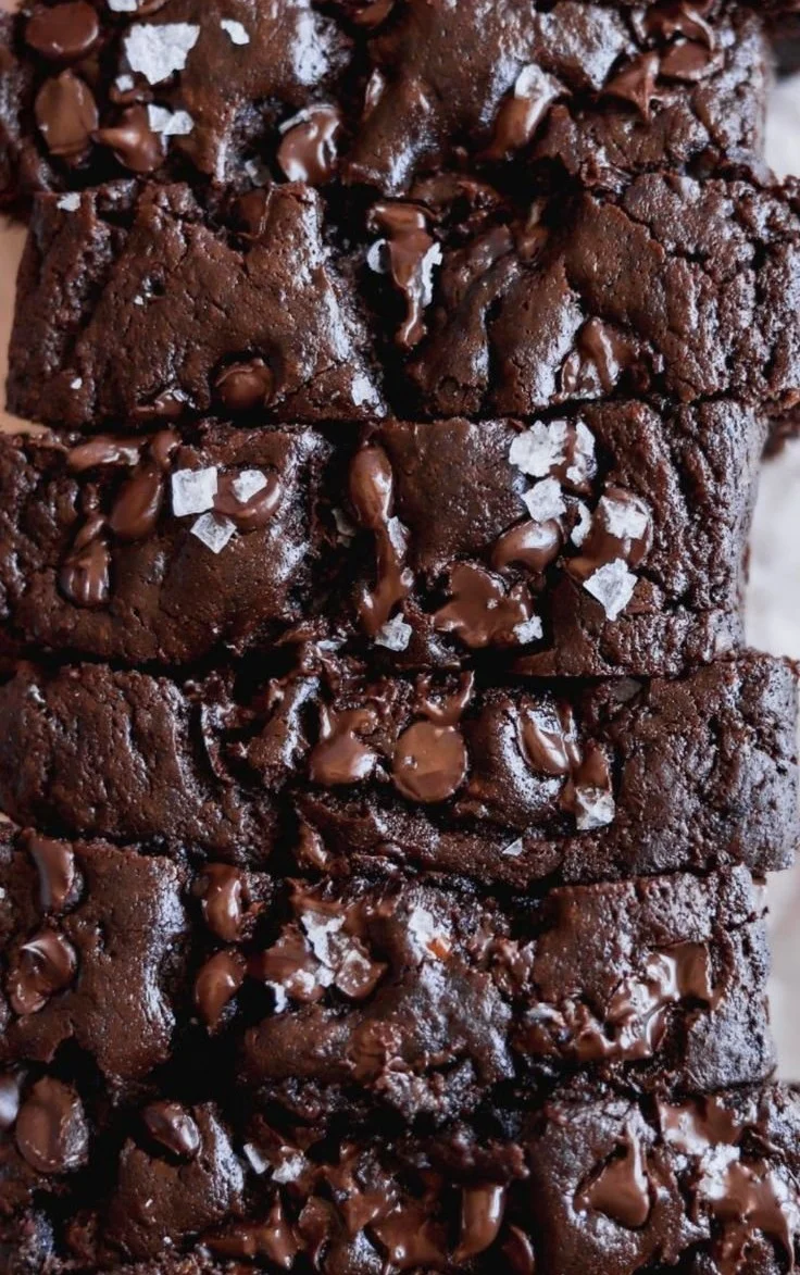 Slice of double chocolate banana bread with chocolate chips on a rustic wooden table