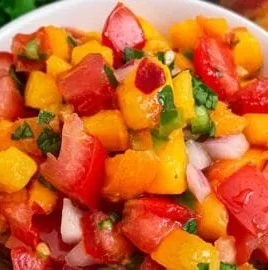 Fresh peach salsa served in a bowl, ideal for summer dishes and parties.