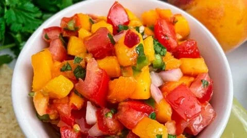 Fresh peach salsa served in a bowl, ideal for summer dishes and parties.