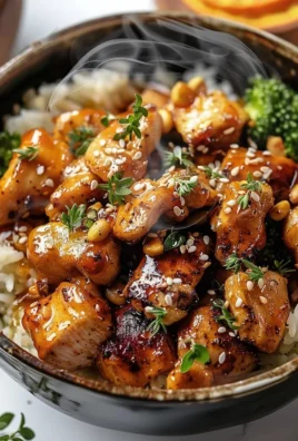Bowl of easy hot honey chicken with fresh vegetables and rice