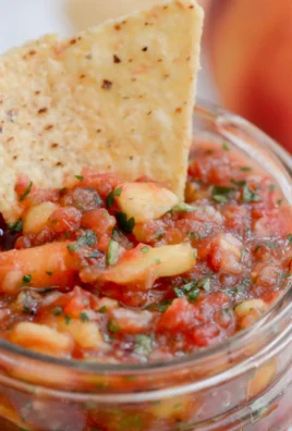 Bowl of easy homemade peach salsa with fresh ingredients.